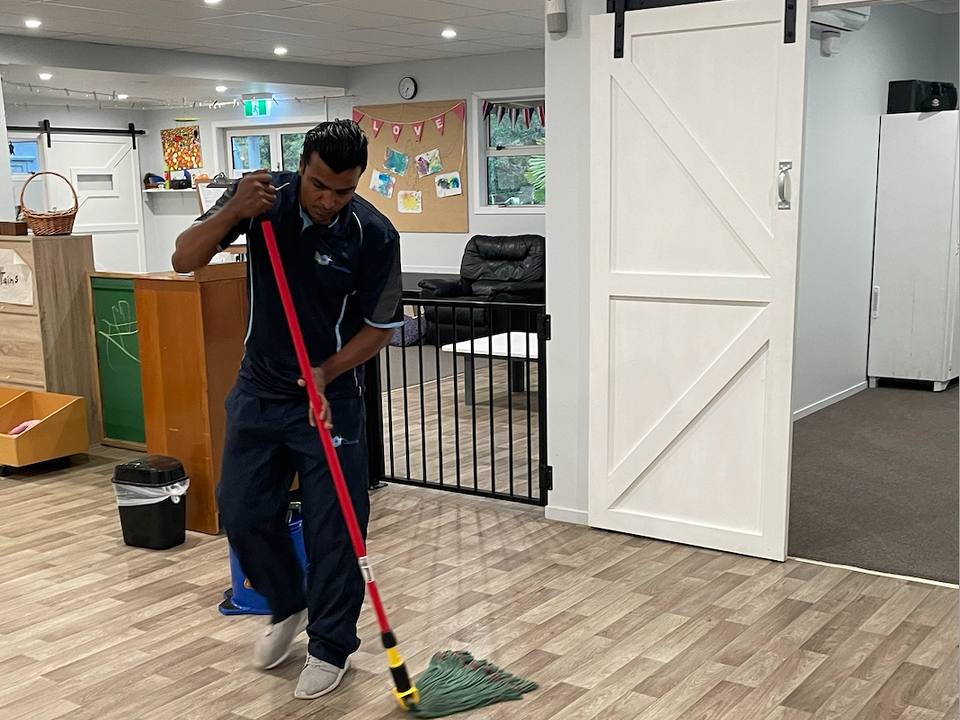 Clean Rite worker cleaning floor